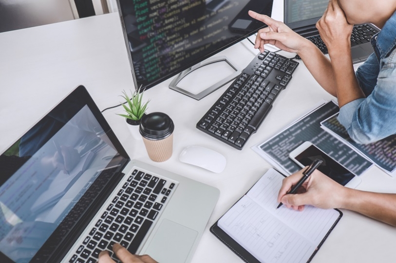 Developers writing code at modern office